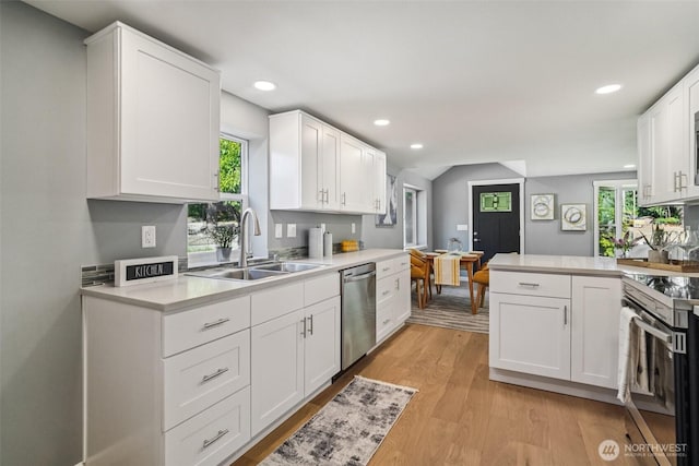 14427 156th Ave SE, Renton, WA 98059 - kitchen with stainless steel appliances, light countertops, recessed lighting, white cabinets, and vaulted ceiling
