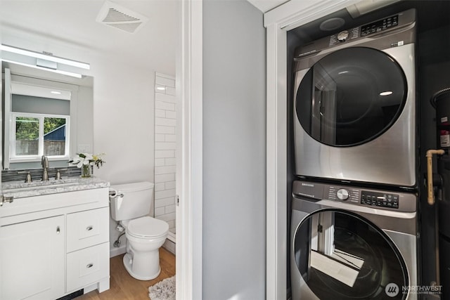 14427 156th Ave SE, Renton, WA 98059 - laundry area with estacked washer and dryer and light wood-style floors
