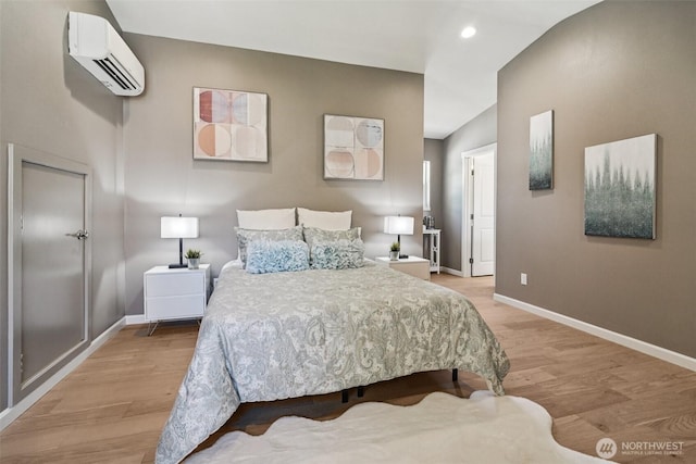 14427 156th Ave SE, Renton, WA 98059 - bedroom featuring a wall mounted AC, light wood-style floors, and recessed lighting