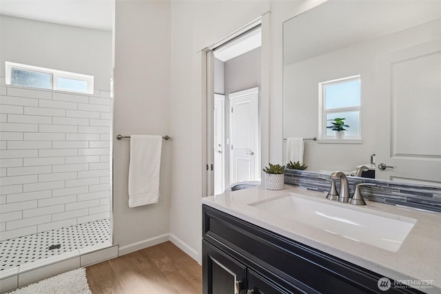 14427 156th Ave SE, Renton, WA 98059 - bathroom featuring vanity, tiled shower, and wood finished floors