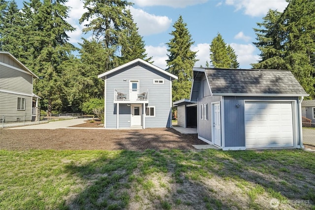 14427 156th Ave SE, Renton, WA 98059 - back of property featuring a balcony, an outdoor structure, a detached garage, and roof with shingles