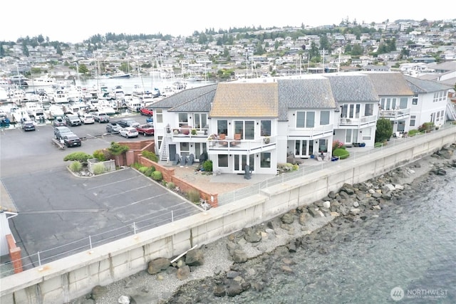 2401 Skyline Way Unit 201E, Anacortes, WA 98221 - back of house with uncovered parking, a fenced backyard, a balcony, and a residential view