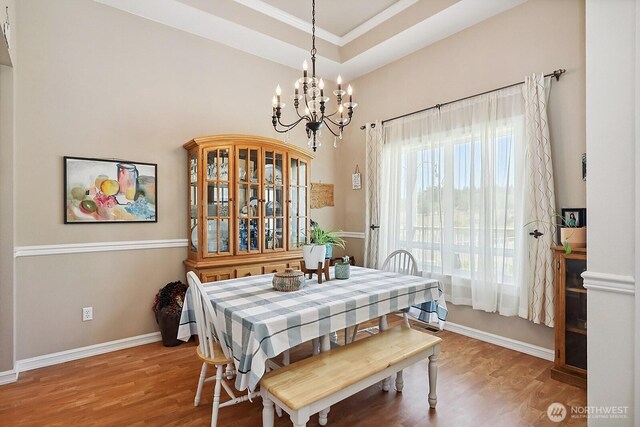 505 Woodland Rd, Goldendale, WA 98620 - dining area featuring a chandelier, light wood-type flooring, ornamental molding, and a raised ceiling