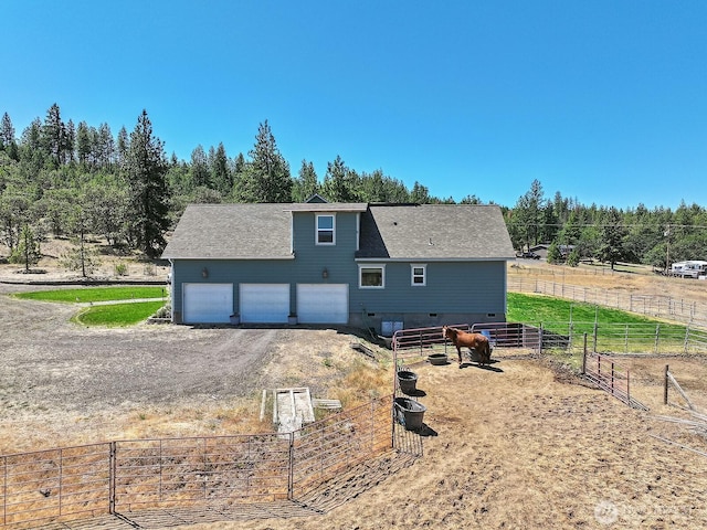 505 Woodland Rd, Goldendale, WA 98620 - rear view of house featuring a garage, dirt driveway, and crawl space