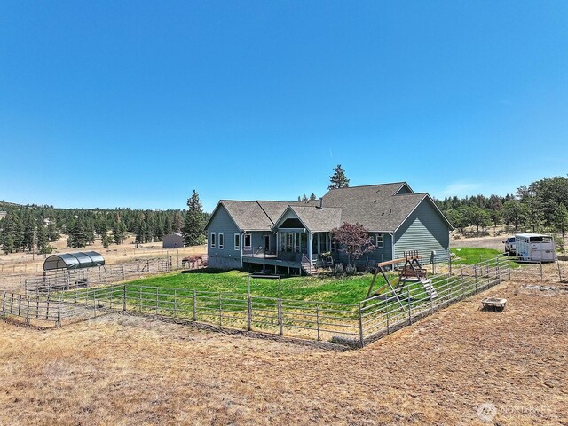 505 Woodland Rd, Goldendale, WA 98620 - rear view of house with an outdoor structure, a shingled roof, and a yard