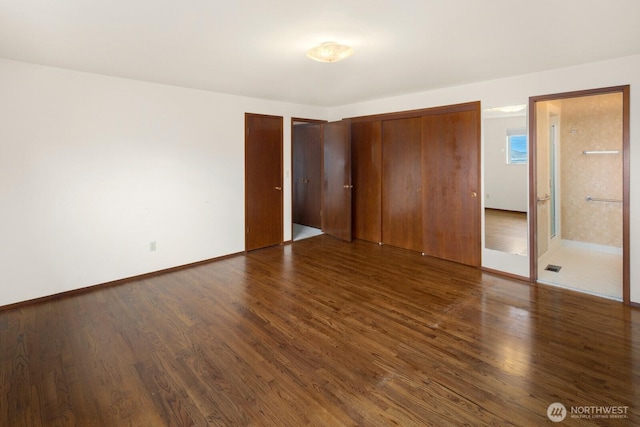 5621 SW Manning St, Seattle, WA 98116 - unfurnished bedroom with wood finished floors and multiple closets