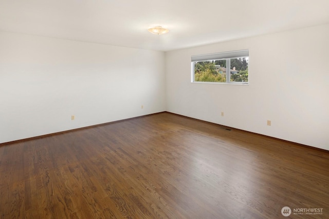 5621 SW Manning St, Seattle, WA 98116 - unfurnished room with wood finished floors and baseboards