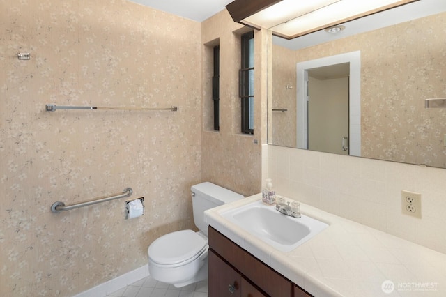 5621 SW Manning St, Seattle, WA 98116 - bathroom with vanity, tile patterned floors, wallpapered walls, and backsplash