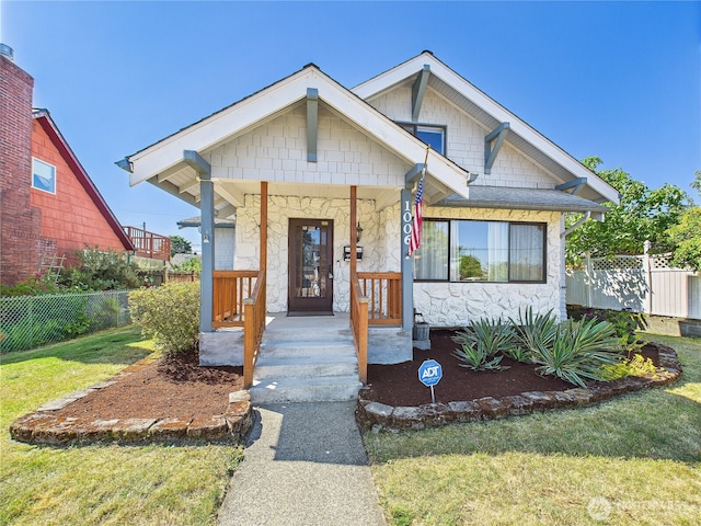1006 E Harrison St, Tacoma, WA 98404 - view of front of house featuring stone siding and a porch