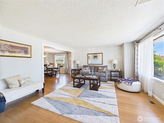 1006 E Harrison St, Tacoma, WA 98404 - living area featuring a textured ceiling and wood finished floors
