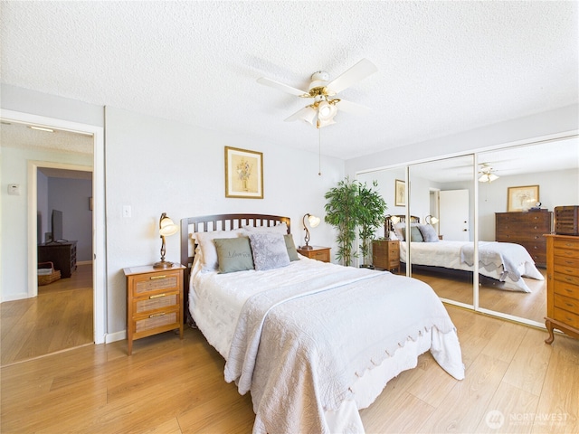 1006 E Harrison St, Tacoma, WA 98404 - bedroom with light wood-style floors, a textured ceiling, ceiling fan, and a closet