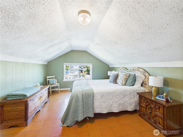 1006 E Harrison St, Tacoma, WA 98404 - bedroom with lofted ceiling, tile patterned floors, a textured ceiling, and wooden walls