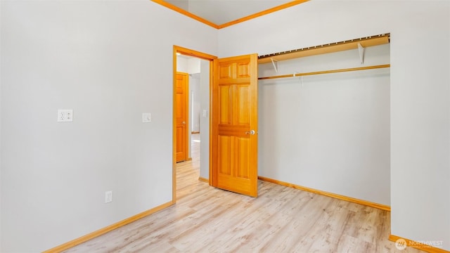 250 E Crest Ln, Grapeview, WA 98546 - unfurnished bedroom featuring wood finished floors, a closet, and ornamental molding