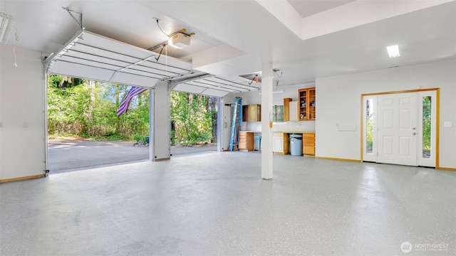 250 E Crest Ln, Grapeview, WA 98546 - garage featuring baseboards and a garage door opener