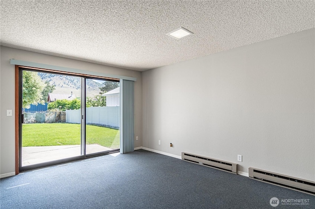 228 E Gibson Ave, Chelan, WA 98816 - carpeted spare room featuring baseboard heating and a textured ceiling
