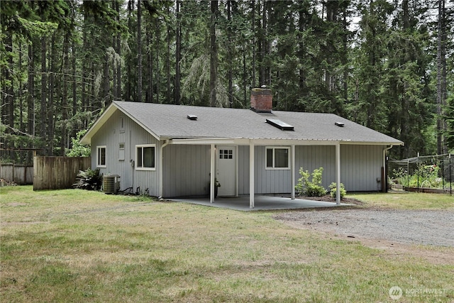 4907 Pinewood Cir, Langley, WA 98260 - ranch-style house with a chimney, a patio area, and a view of trees