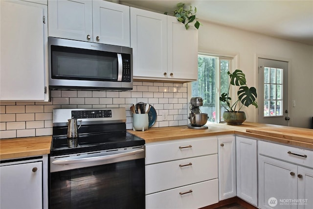 4907 Pinewood Cir, Langley, WA 98260 - kitchen featuring butcher block countertops, stainless steel appliances, white cabinetry, and decorative backsplash