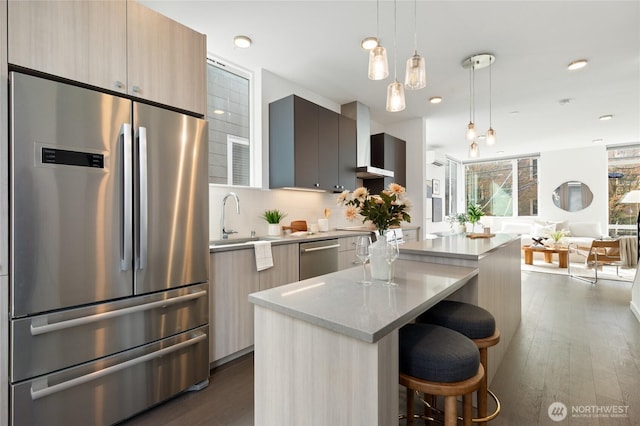 410A 10th Ave E, Seattle, WA 98102 - kitchen featuring appliances with stainless steel finishes, modern cabinets, a kitchen island, a kitchen breakfast bar, and recessed lighting