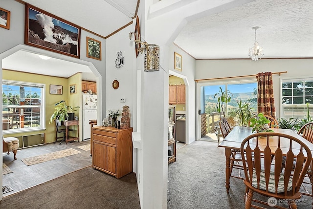 55 Mott Rd, Lyle, WA 98635 - carpeted dining space with arched walkways, a chandelier, and ornamental molding