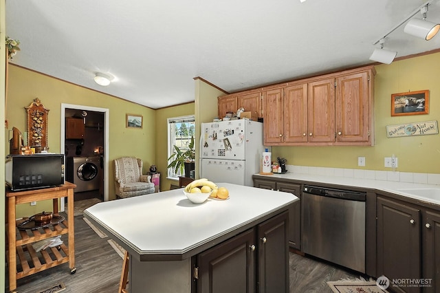 55 Mott Rd, Lyle, WA 98635 - kitchen featuring stainless steel dishwasher, washer / dryer, freestanding refrigerator, dark wood finished floors, and light countertops
