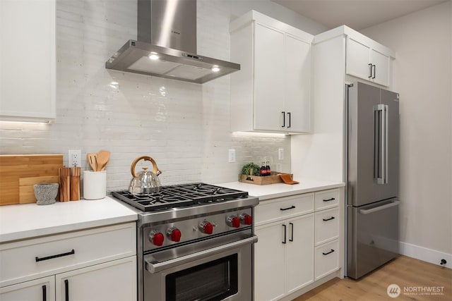 10505 NE 112th St, Kirkland, WA 98033 - kitchen with wall chimney exhaust hood, stainless steel appliances, backsplash, light wood-type flooring, and white cabinets