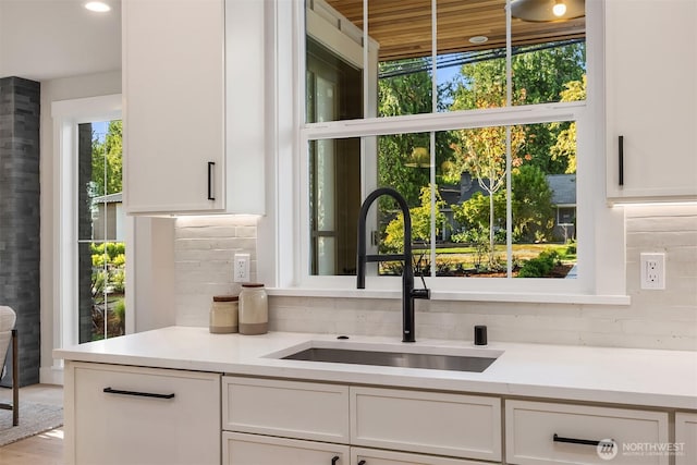 10505 NE 112th St, Kirkland, WA 98033 - kitchen with plenty of natural light, white cabinetry, and tasteful backsplash