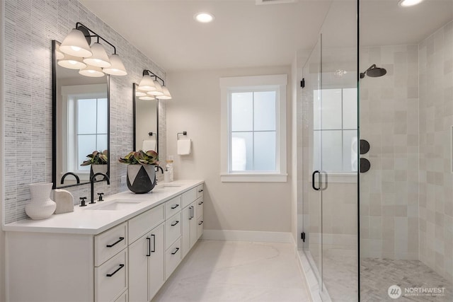 10505 NE 112th St, Kirkland, WA 98033 - bathroom featuring double vanity, plenty of natural light, a shower stall, recessed lighting, and decorative backsplash