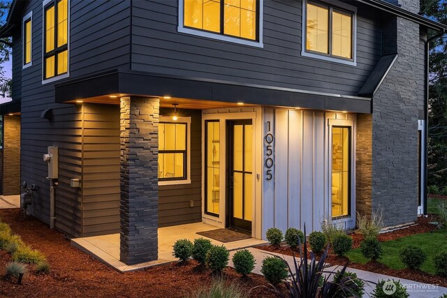 10505 NE 112th St, Kirkland, WA 98033 - view of front facade featuring board and batten siding and a chimney