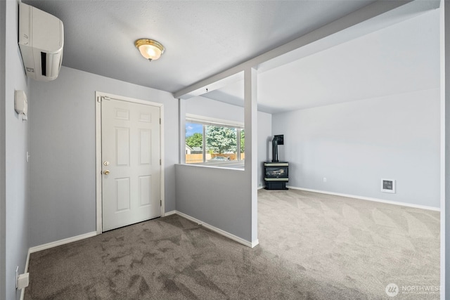 610 128th St S, Tacoma, WA 98444 - unfurnished bedroom featuring carpet, a wall mounted air conditioner, and a wood stove