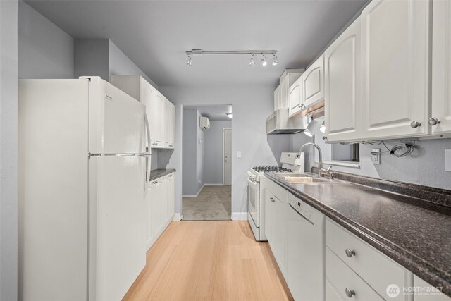 610 128th St S, Tacoma, WA 98444 - kitchen with white appliances, white cabinetry, light wood-style floors, under cabinet range hood, and a wall mounted AC