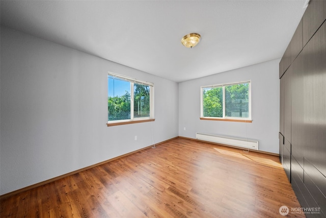 610 128th St S, Tacoma, WA 98444 - unfurnished room featuring a baseboard heating unit and light wood-style floors