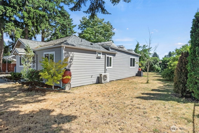 610 128th St S, Tacoma, WA 98444 - view of side of property with a lawn and roof with shingles