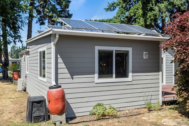 610 128th St S, Tacoma, WA 98444 - view of home's exterior with solar panels and a metal roof