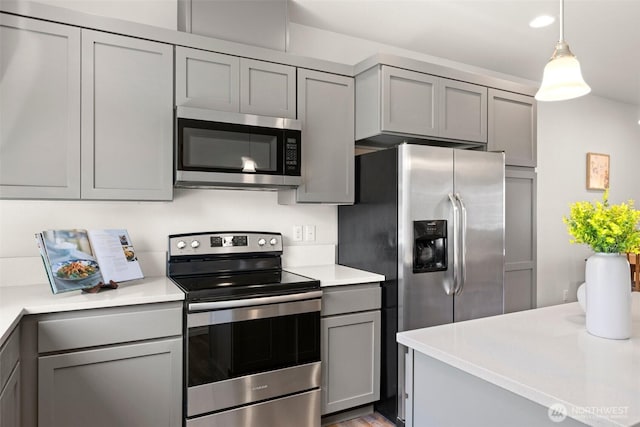 3312 156th St SW Unit E4, Lynnwood, WA 98087 - kitchen featuring appliances with stainless steel finishes, gray cabinetry, light countertops, and decorative light fixtures