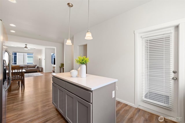 3312 156th St SW Unit E4, Lynnwood, WA 98087 - kitchen featuring gray cabinetry, hanging light fixtures, wood finished floors, a center island, and ceiling fan