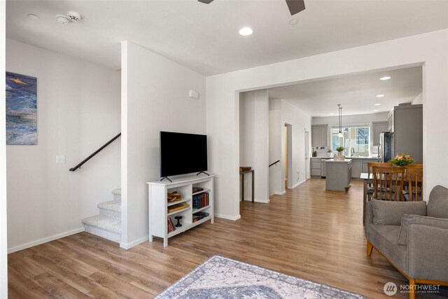 3312 156th St SW Unit E4, Lynnwood, WA 98087 - living room featuring light wood-style floors, ceiling fan, recessed lighting, and stairway