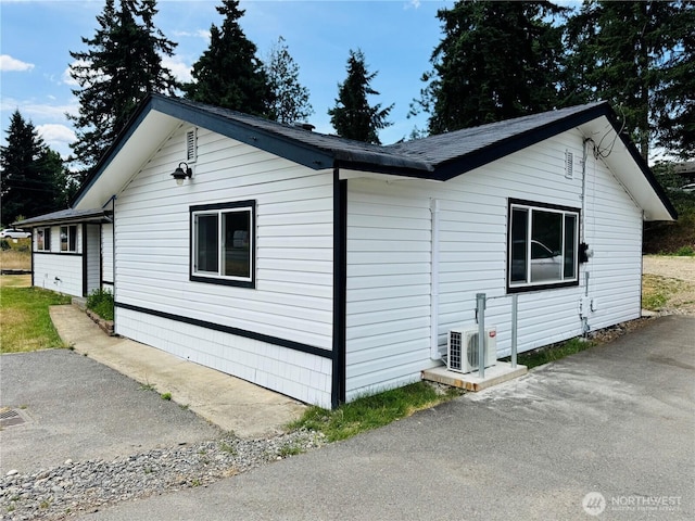 12706 94th Ave E, Puyallup, WA 98373 - view of side of property with an ac unit and roof with shingles