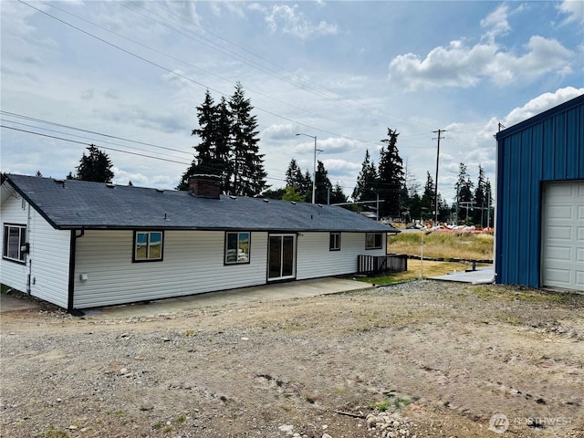 12706 94th Ave E, Puyallup, WA 98373 - rear view of property featuring a chimney and board and batten siding