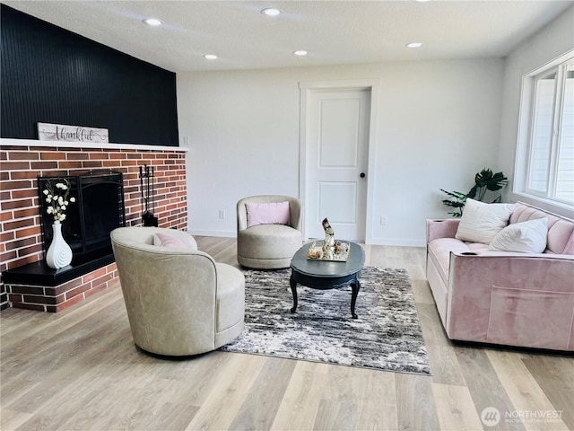 12706 94th Ave E, Puyallup, WA 98373 - living area featuring wood finished floors, a brick fireplace, recessed lighting, and a textured ceiling