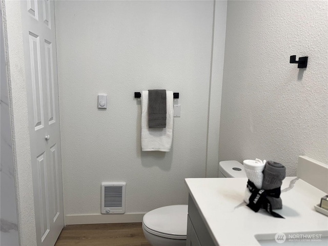 12706 94th Ave E, Puyallup, WA 98373 - bathroom featuring heating unit, wood finished floors, and vanity