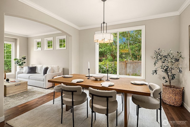 3606 Monterey Ct NE, Renton, WA 98056 - dining area featuring dark wood-style flooring, crown molding, and arched walkways