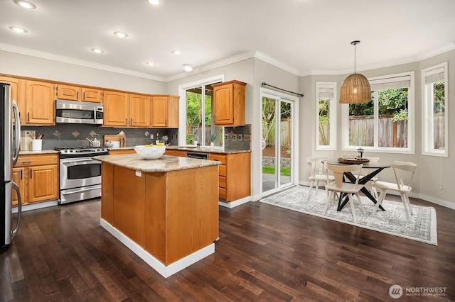 3606 Monterey Ct NE, Renton, WA 98056 - kitchen with stainless steel appliances, dark wood-style flooring, a kitchen island, tasteful backsplash, and recessed lighting