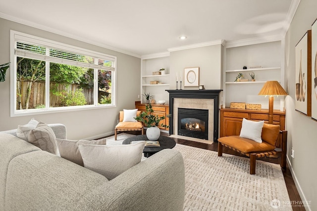 3606 Monterey Ct NE, Renton, WA 98056 - living area featuring crown molding, wood finished floors, a tiled fireplace, and built in features