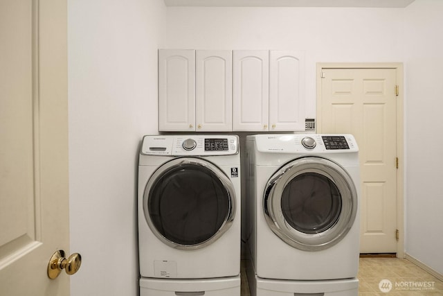 3606 Monterey Ct NE, Renton, WA 98056 - laundry area featuring separate washer and dryer, cabinet space, and light tile patterned floors
