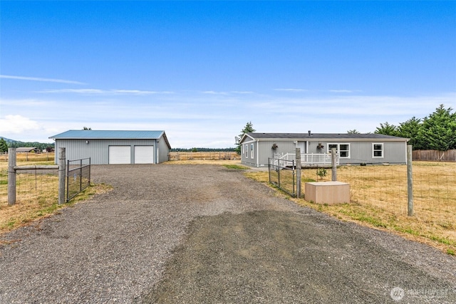 8222 Bordeaux Rd SW, Olympia, WA 98512 - view of front facade featuring an outbuilding, a garage, and gravel driveway