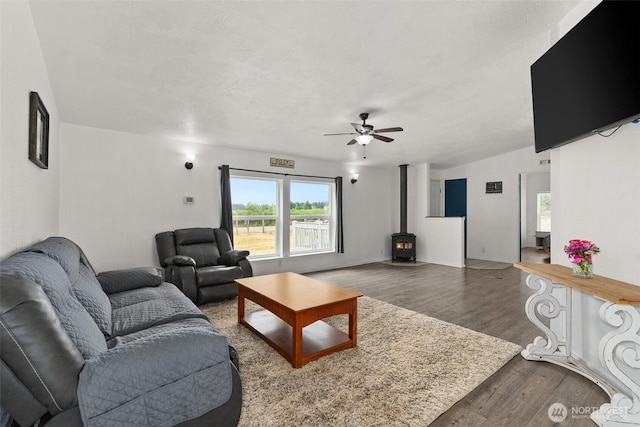 8222 Bordeaux Rd SW, Olympia, WA 98512 - living area featuring a wood stove, ceiling fan, and wood finished floors