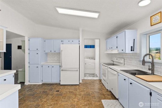 8222 Bordeaux Rd SW, Olympia, WA 98512 - kitchen featuring white appliances, washer / dryer, backsplash, vaulted ceiling, and light countertops