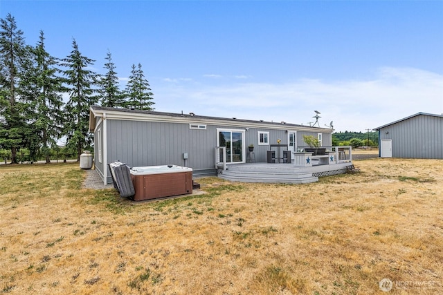 8222 Bordeaux Rd SW, Olympia, WA 98512 - back of house with a hot tub, a wooden deck, and a lawn