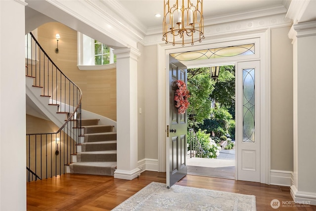 2001 Broadmoor Dr E, Seattle, WA 98112 - foyer with wood finished floors, stairway, a chandelier, and crown molding
