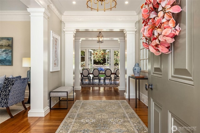 2001 Broadmoor Dr E, Seattle, WA 98112 - foyer entrance with a chandelier, ornate columns, dark wood-style flooring, and ornamental molding